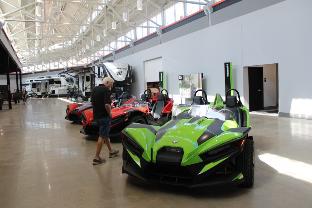 A shopper checks out a Polaris Slingshot car in the newly redeveloped mall in Marion earlier this year. (Credit: Janelle O’Dea/Illinois Answers Project)