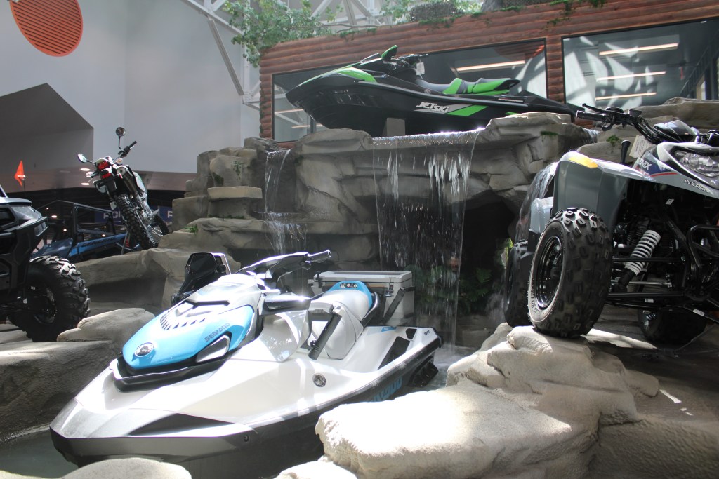 Powersport vehicles flank an indoor waterfall at the newly redeveloped Marion mall. (Credit: Janelle O’Dea/Illinois Answers Project)